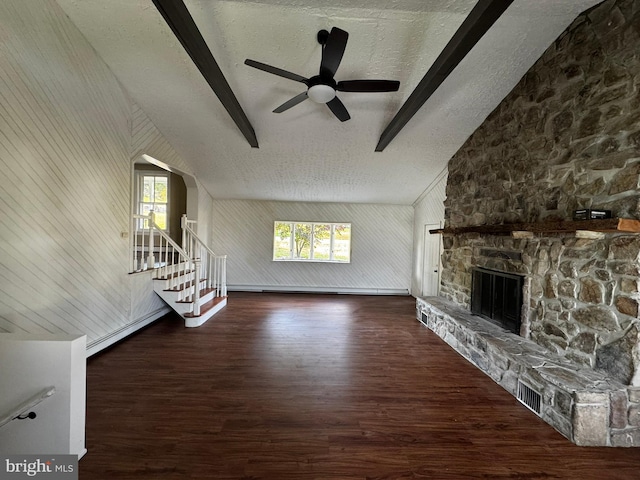 unfurnished living room with a fireplace, dark hardwood / wood-style floors, a textured ceiling, and plenty of natural light