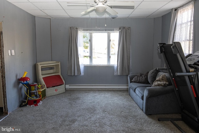 playroom with a baseboard radiator, a drop ceiling, carpet flooring, and ceiling fan