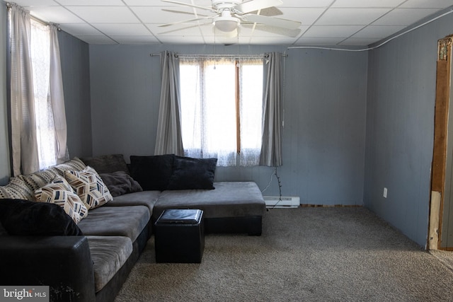 carpeted living room featuring a paneled ceiling, baseboard heating, and ceiling fan