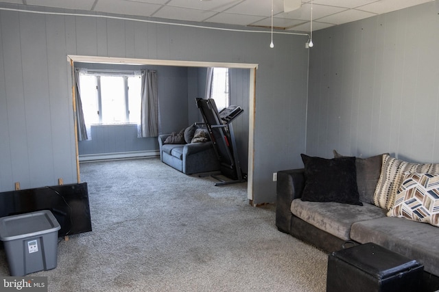 living room with a paneled ceiling, carpet floors, and baseboard heating