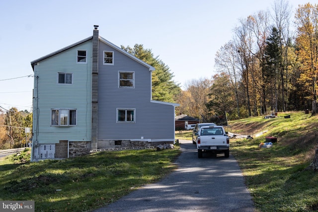 view of home's exterior with a lawn