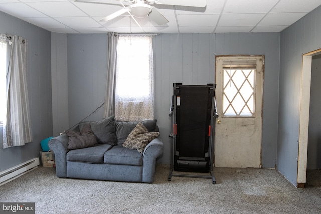 living room featuring a wealth of natural light, a drop ceiling, light carpet, and ceiling fan