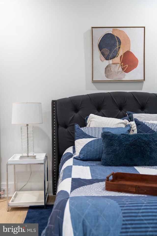 bedroom with hardwood / wood-style flooring