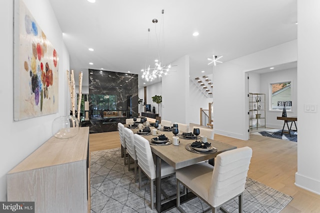 dining space with light hardwood / wood-style floors and a chandelier