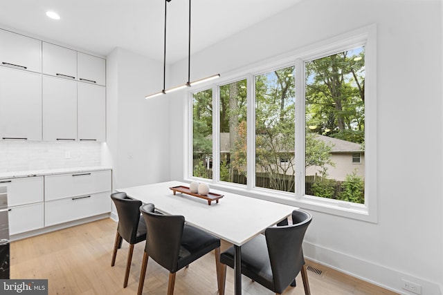 dining space with light hardwood / wood-style flooring