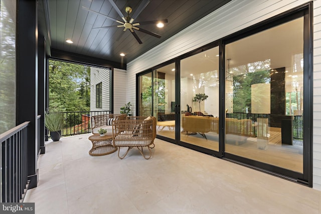 sunroom featuring wooden ceiling and ceiling fan