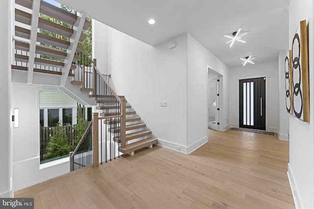 foyer entrance with light hardwood / wood-style floors