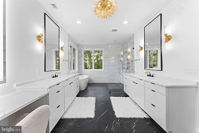 bathroom with vanity, independent shower and bath, and plenty of natural light