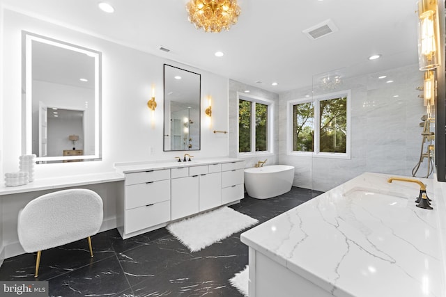 bathroom with vanity, tile walls, and a washtub