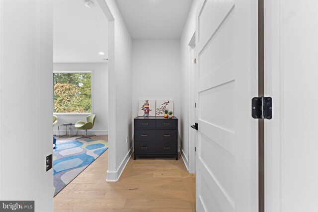 hallway with light hardwood / wood-style flooring