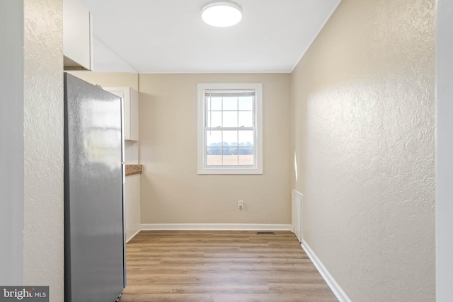 spare room featuring light hardwood / wood-style floors