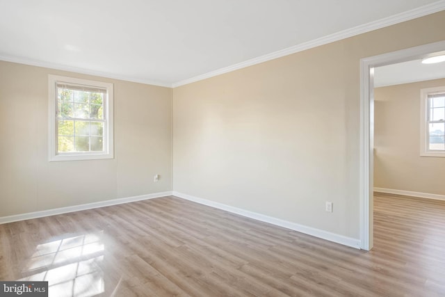 spare room with light hardwood / wood-style floors and ornamental molding