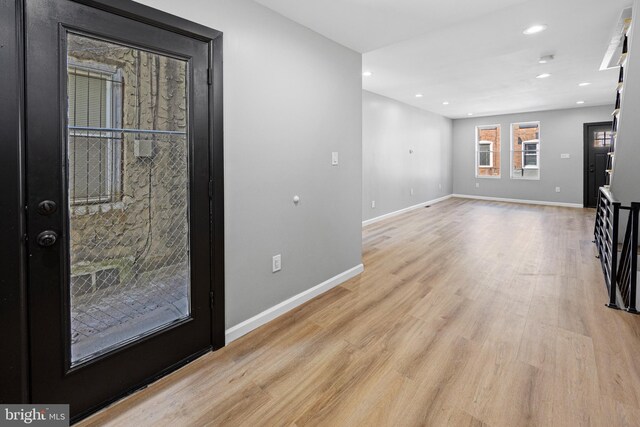 unfurnished living room featuring baseboards, wood finished floors, and recessed lighting