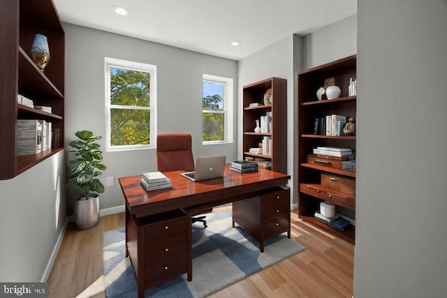 office area featuring recessed lighting, baseboards, and light wood-type flooring