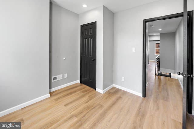 unfurnished bedroom featuring baseboards, visible vents, recessed lighting, and light wood-style floors