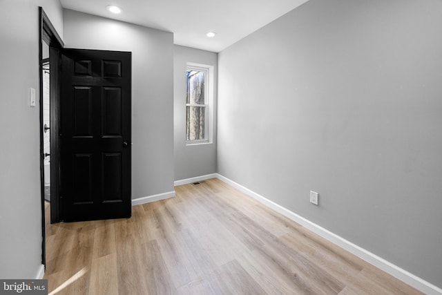 interior space featuring recessed lighting, wood finished floors, visible vents, and baseboards