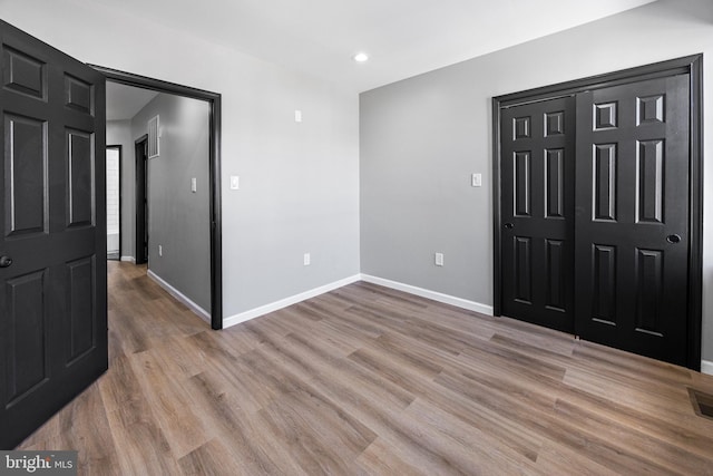 interior space with recessed lighting, light wood-style flooring, visible vents, and baseboards