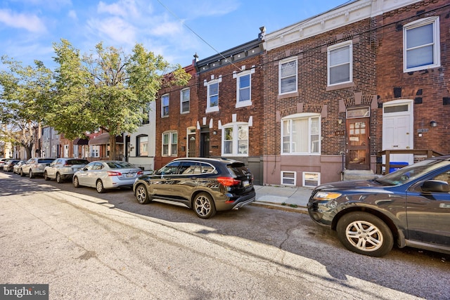 view of front of property featuring brick siding and a residential view