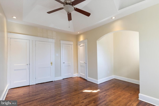 unfurnished bedroom with dark hardwood / wood-style floors and ceiling fan