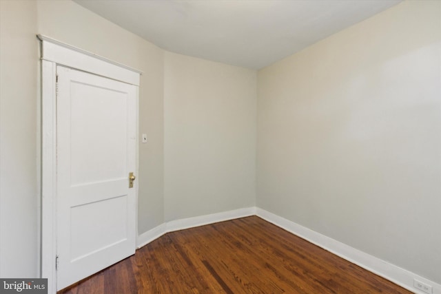 unfurnished room featuring dark wood-type flooring