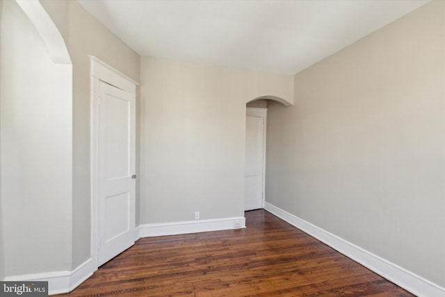 spare room with dark hardwood / wood-style floors