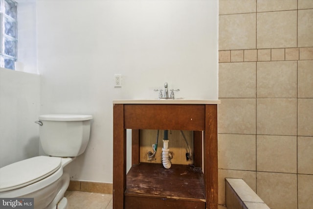 bathroom featuring toilet, sink, and tile patterned floors