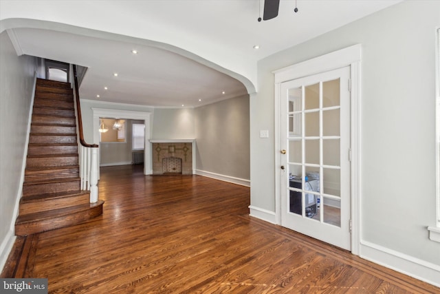 interior space with dark wood-type flooring, ceiling fan, and radiator heating unit