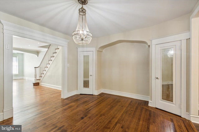 foyer with a notable chandelier and dark hardwood / wood-style floors