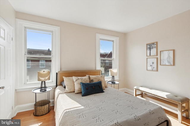 bedroom featuring multiple windows and wood-type flooring