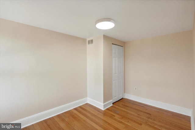 unfurnished room featuring hardwood / wood-style flooring