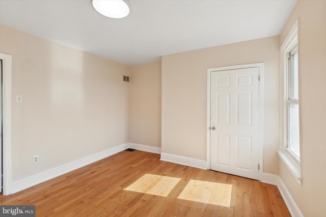 empty room with light hardwood / wood-style floors