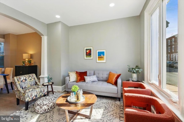 living room featuring wood-type flooring and decorative columns