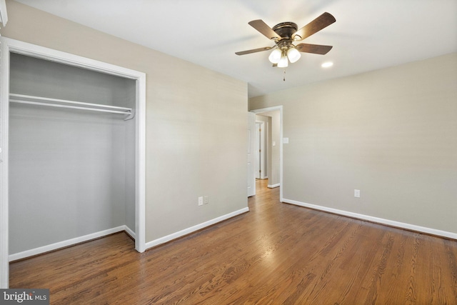 unfurnished bedroom featuring a closet, ceiling fan, and wood-type flooring