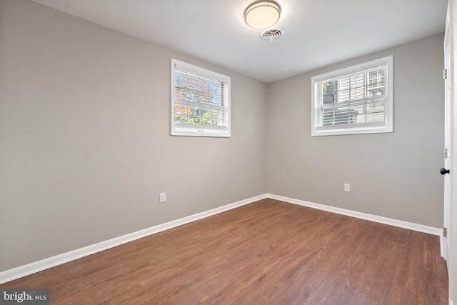 empty room featuring hardwood / wood-style floors and a wealth of natural light