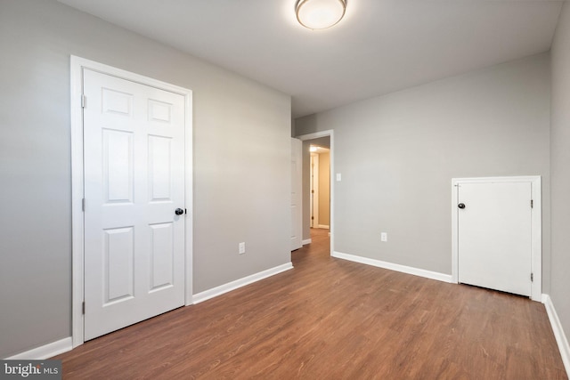 unfurnished bedroom with hardwood / wood-style floors