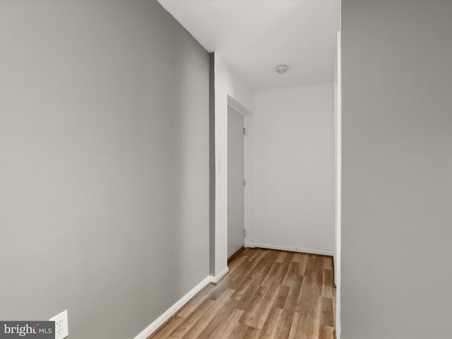 hallway with light hardwood / wood-style flooring