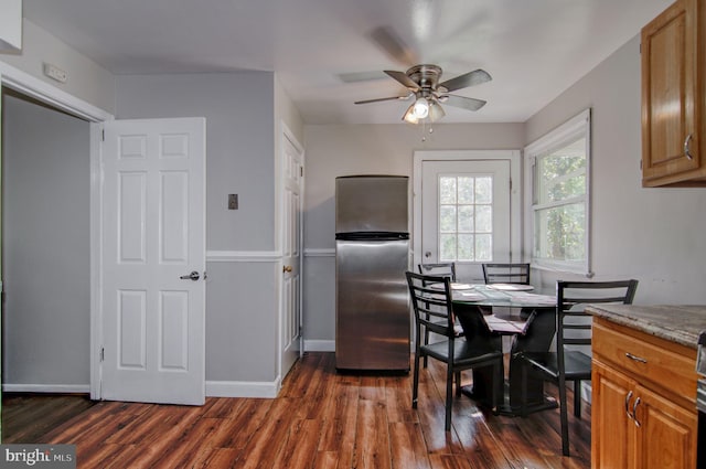 dining area featuring dark wood-type flooring and ceiling fan