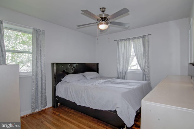 bedroom with wood-type flooring and ceiling fan