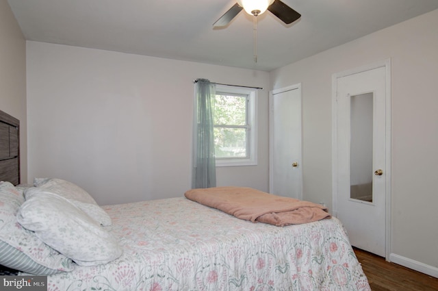 bedroom with dark hardwood / wood-style floors and ceiling fan