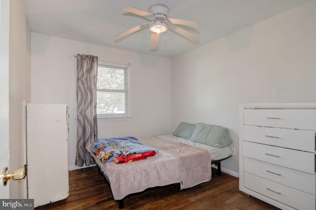 bedroom featuring dark wood-type flooring and ceiling fan