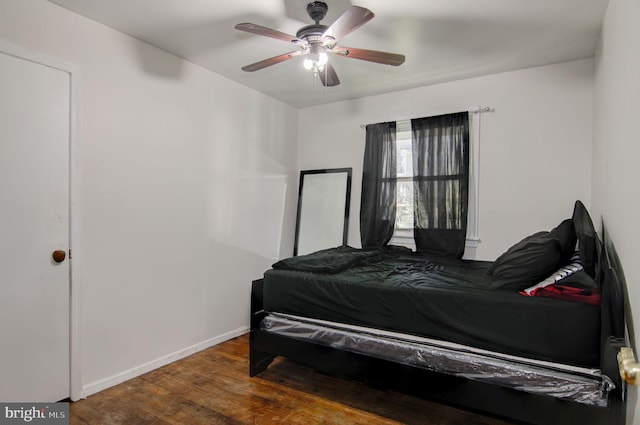 bedroom with ceiling fan and dark hardwood / wood-style flooring