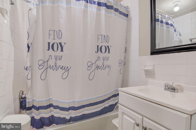 full bathroom with decorative backsplash, tile walls, shower / bath combo with shower curtain, toilet, and vanity