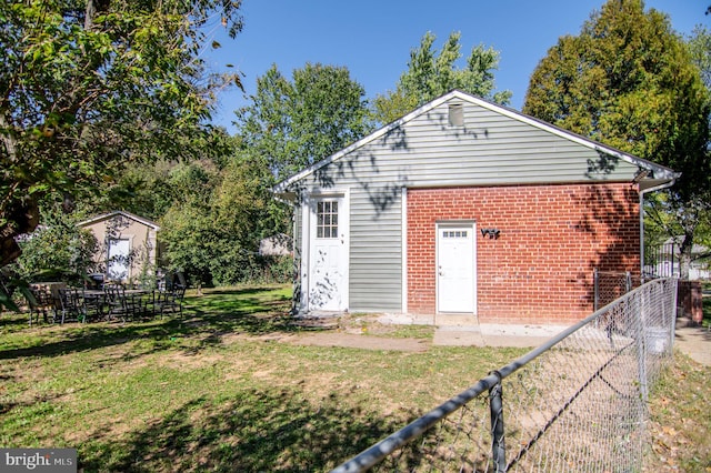 view of outbuilding with a lawn