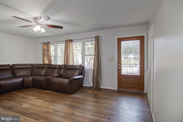 living room with ceiling fan and dark hardwood / wood-style flooring