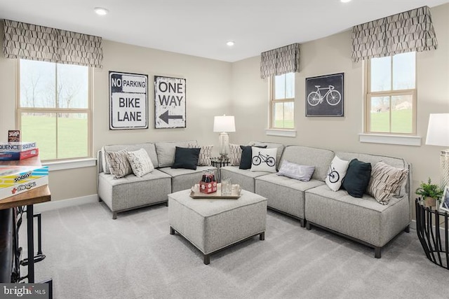 living room featuring light carpet and a healthy amount of sunlight