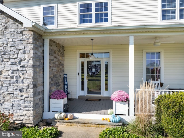 view of exterior entry featuring covered porch