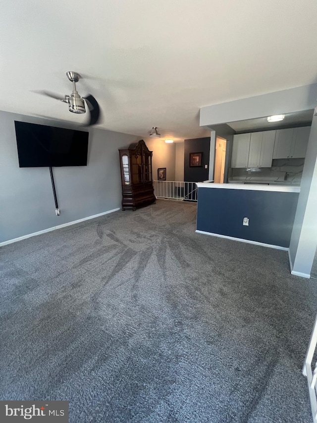 unfurnished living room featuring dark carpet