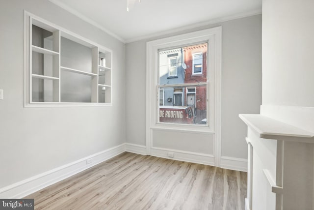 unfurnished dining area with light hardwood / wood-style floors and crown molding