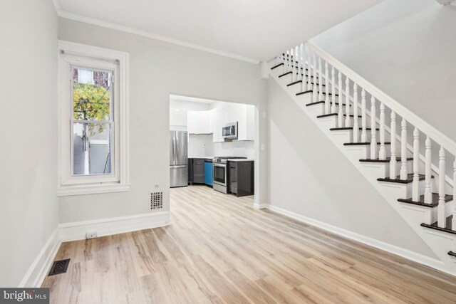 stairway featuring hardwood / wood-style floors and ornamental molding