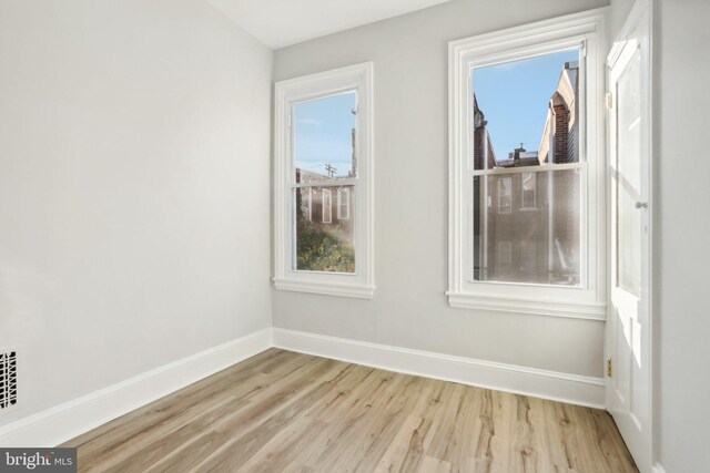 unfurnished room with light hardwood / wood-style floors